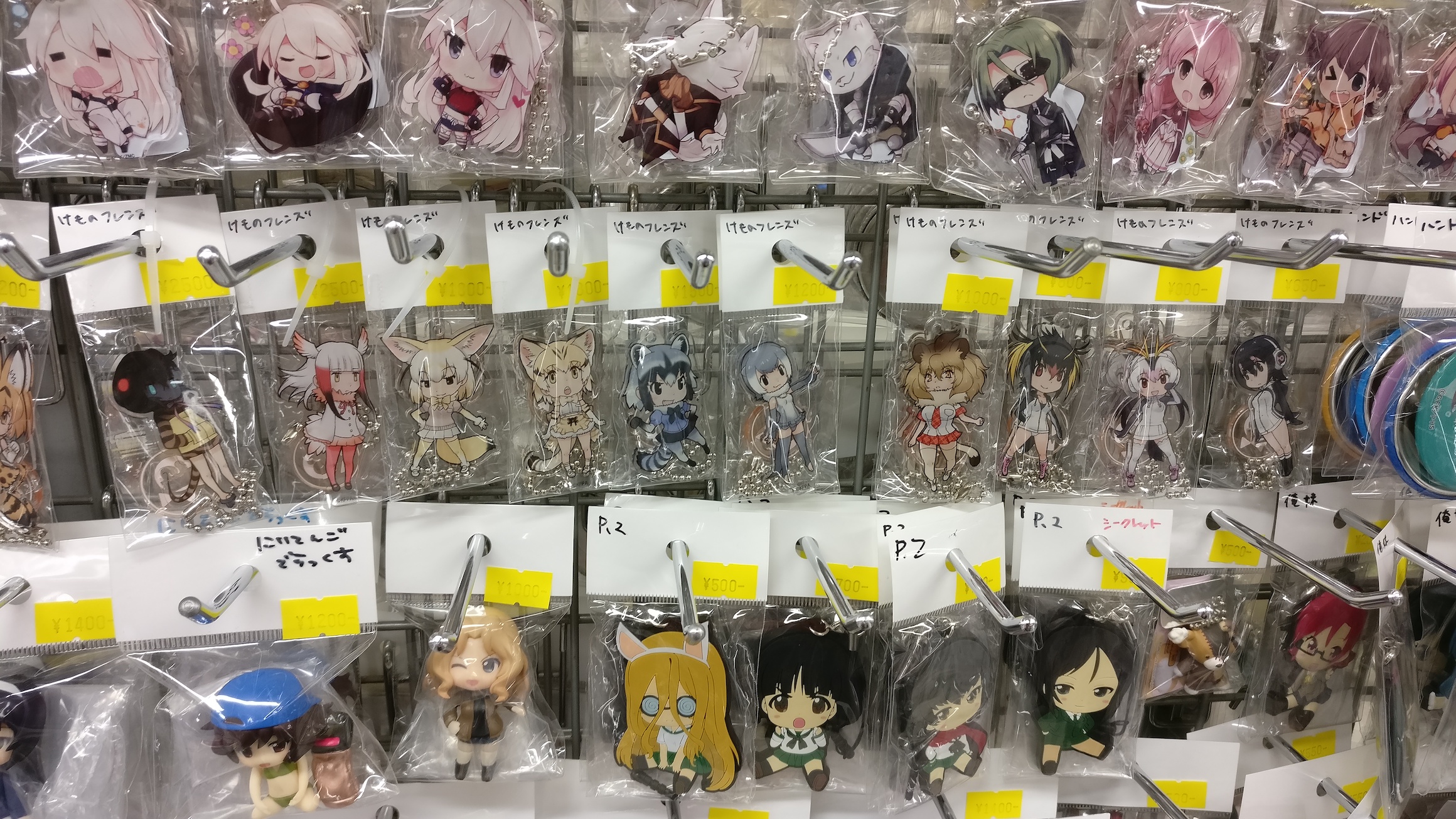 A collection of anime keychains for sale, mostly from Kemono Friends